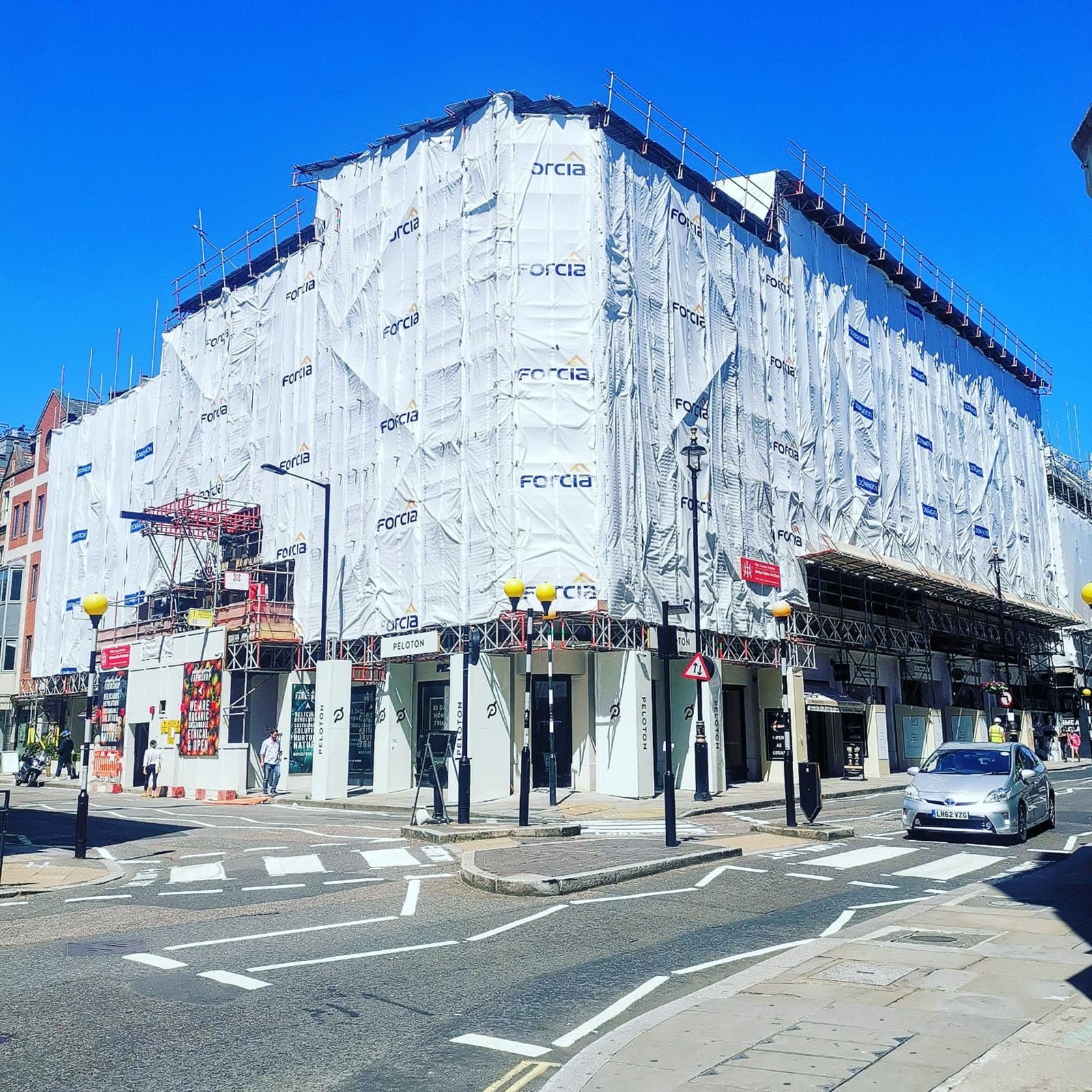 Building covered in scaffolding on a sunny street