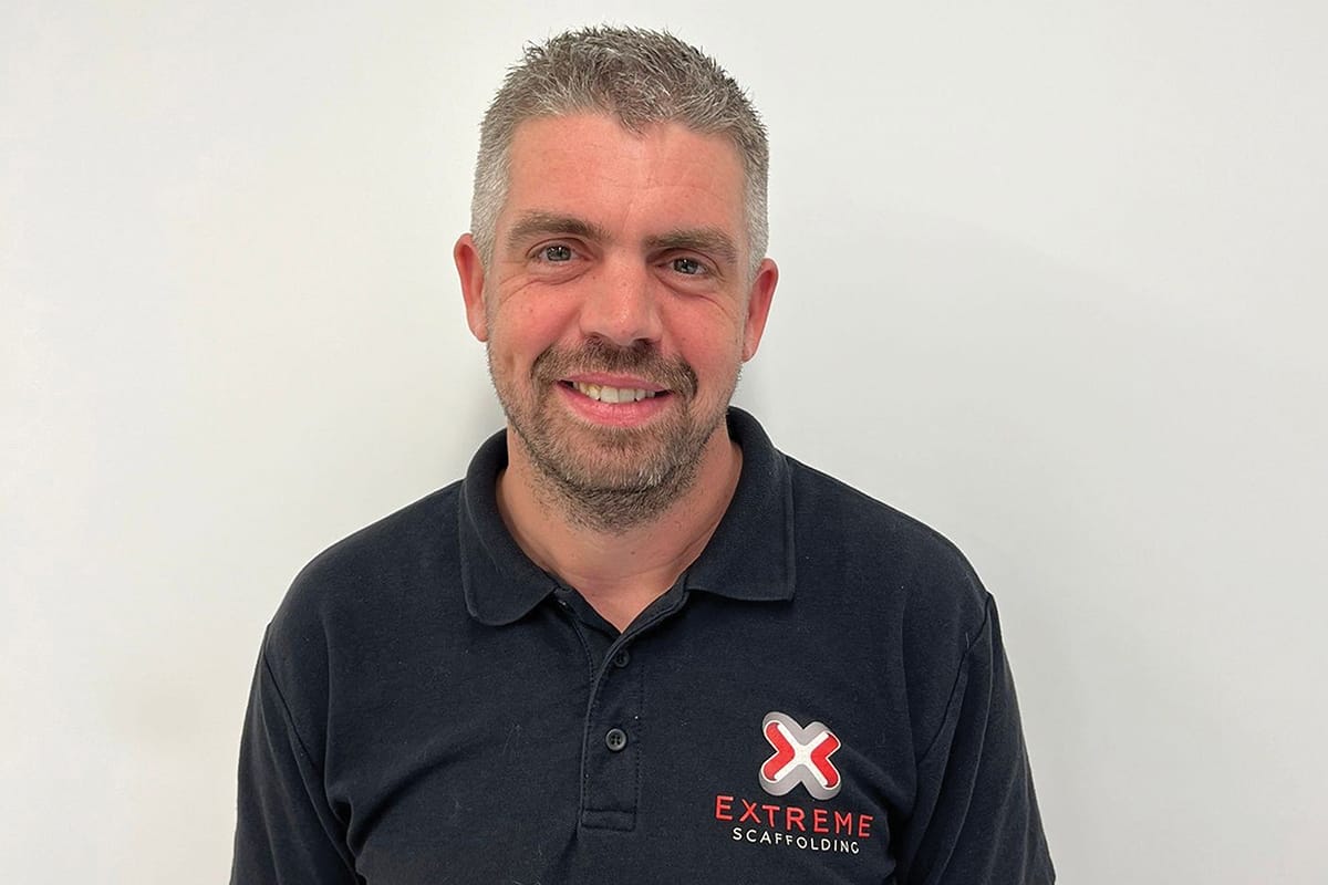 Smiling man in navy company polo shirt