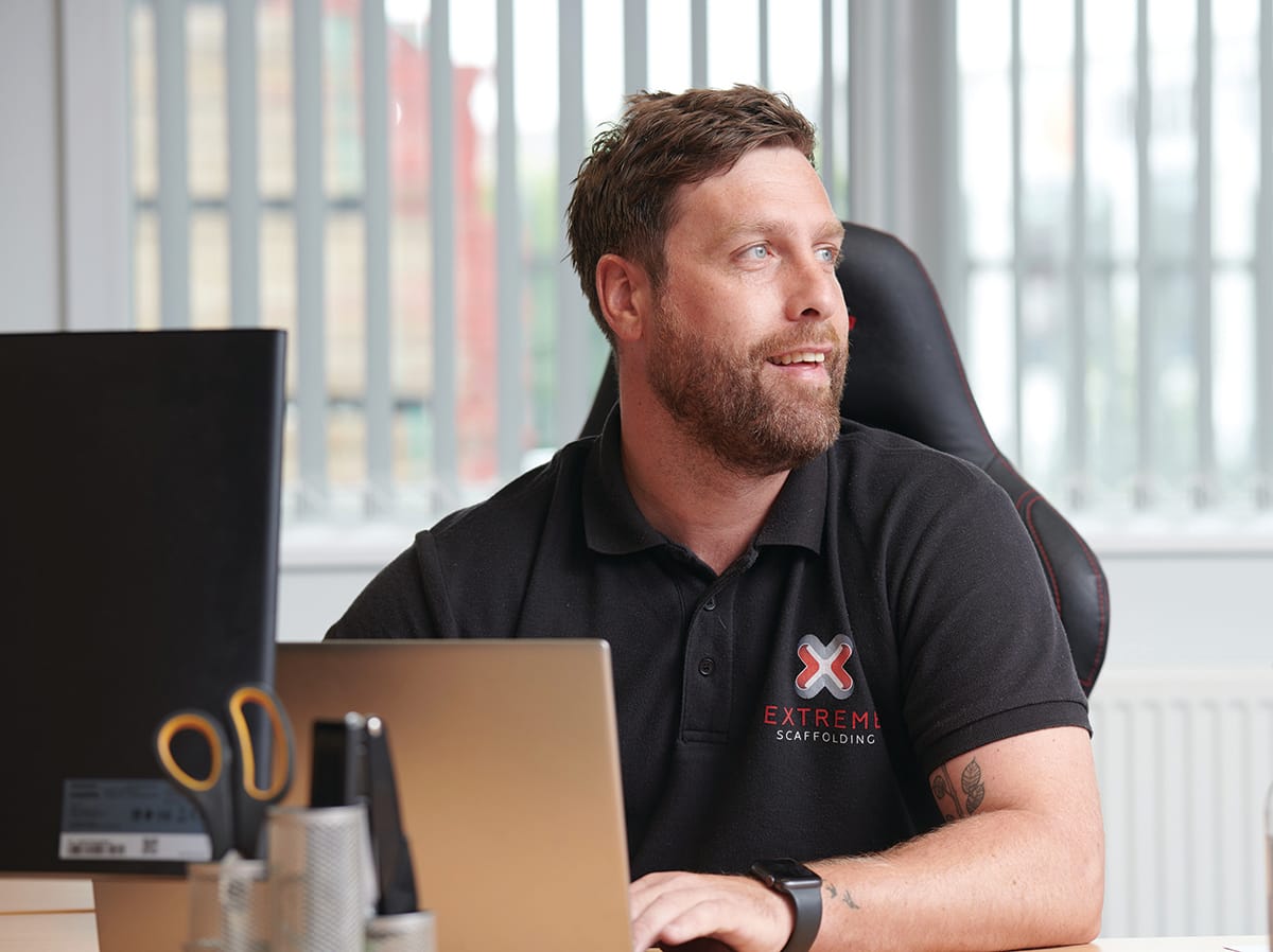 Man in office wearing company polo shirt
