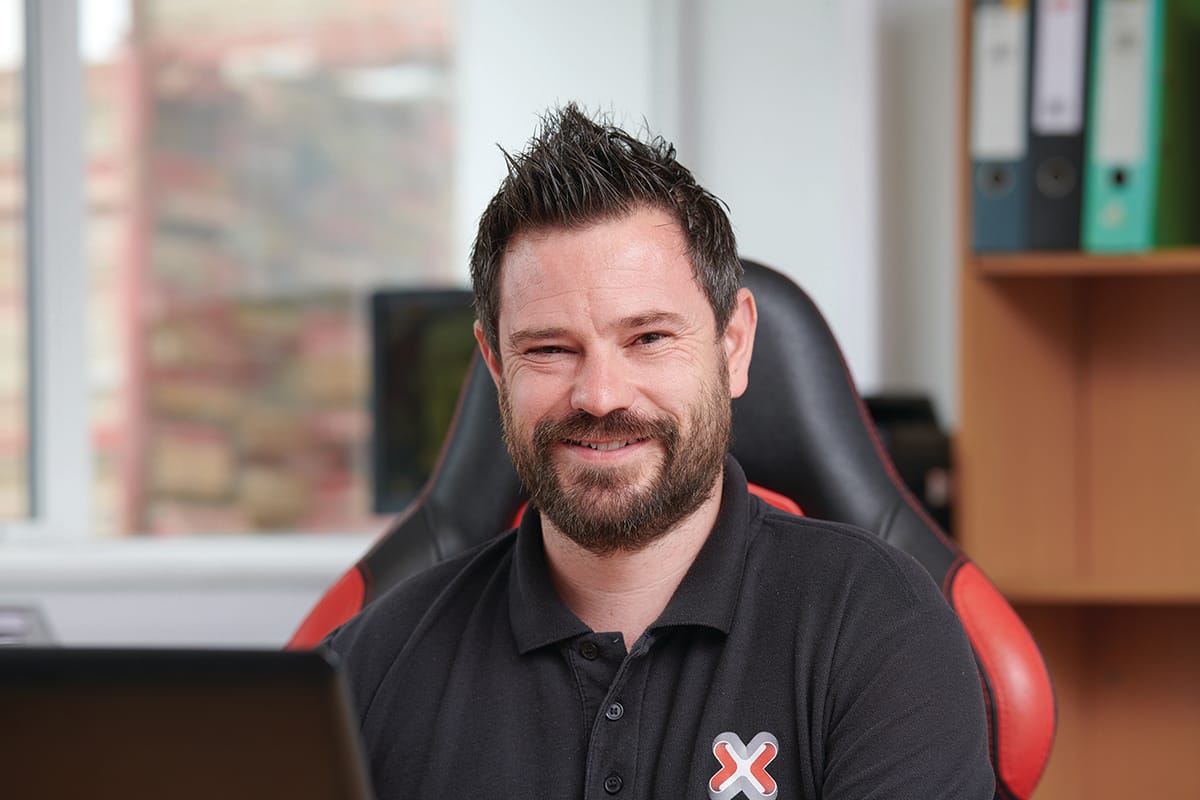 Smiling man at desk in office chair